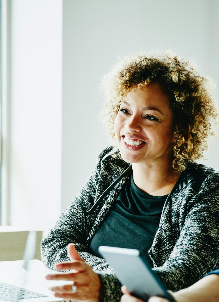Woman in business workplace presenting with her laptop
