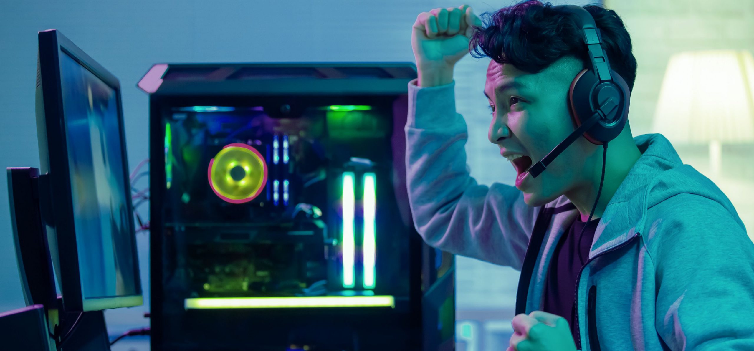 Excited young man playing video games online