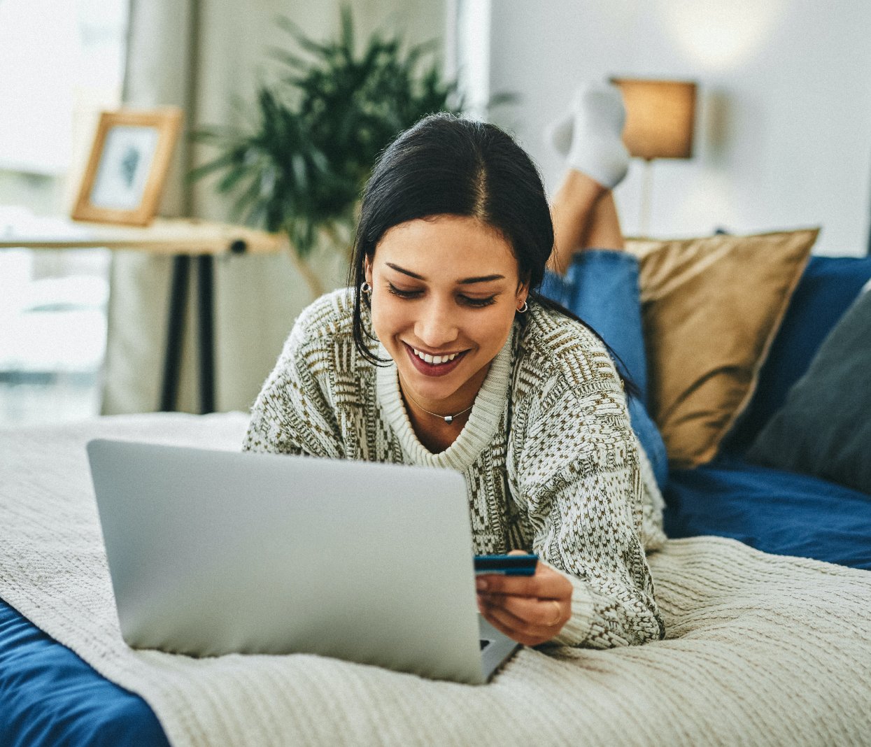 Woman paying her bill using a laptop on her bad