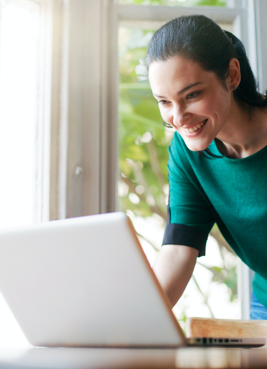 Woman in a green shirt using a laptop