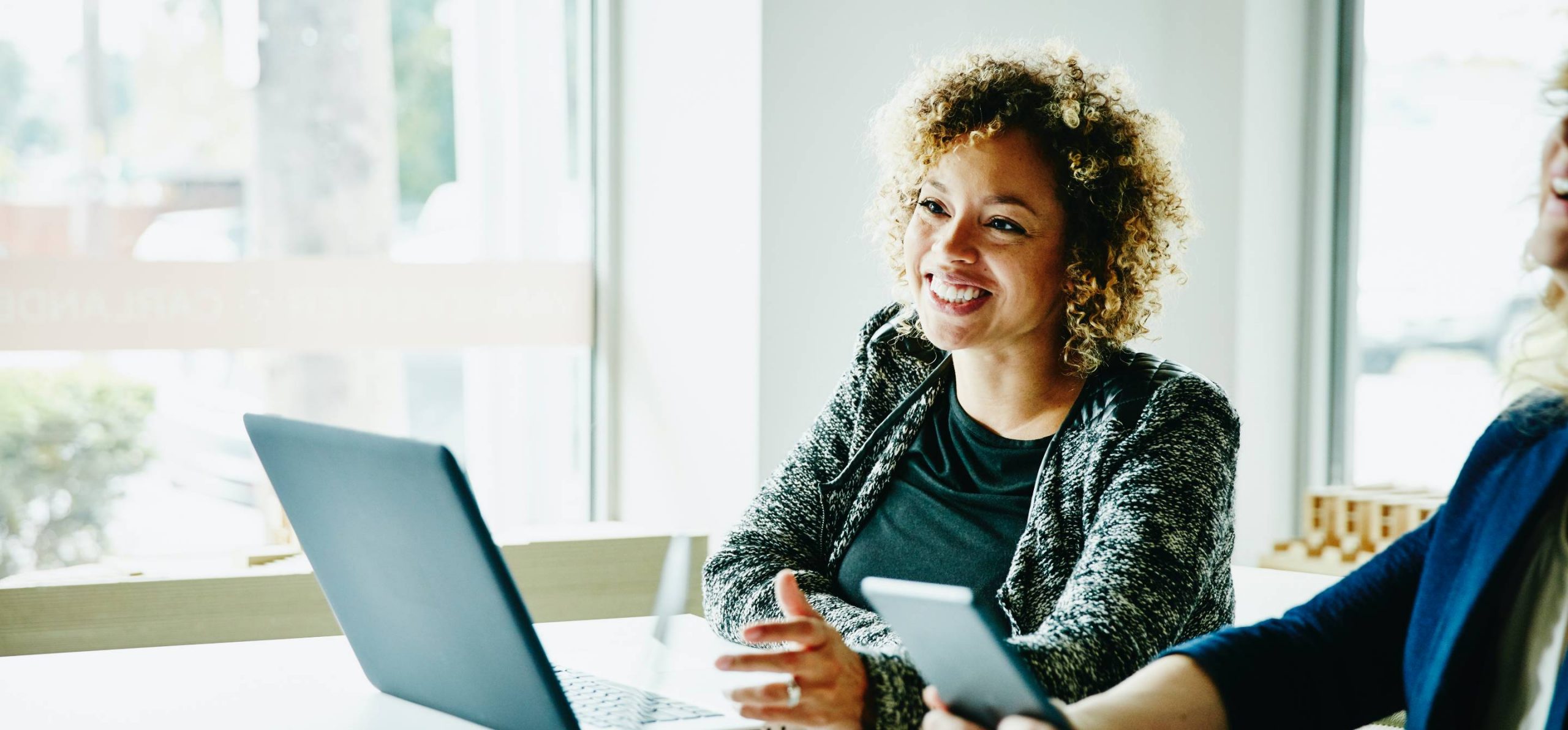 Woman in business workplace presenting with her laptop